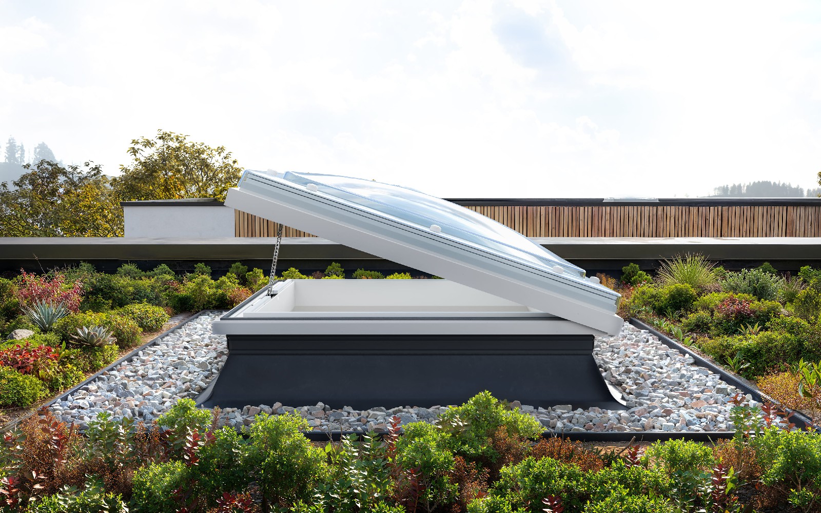Opening Mardome rooflight shown from the side on a commercial flat roof